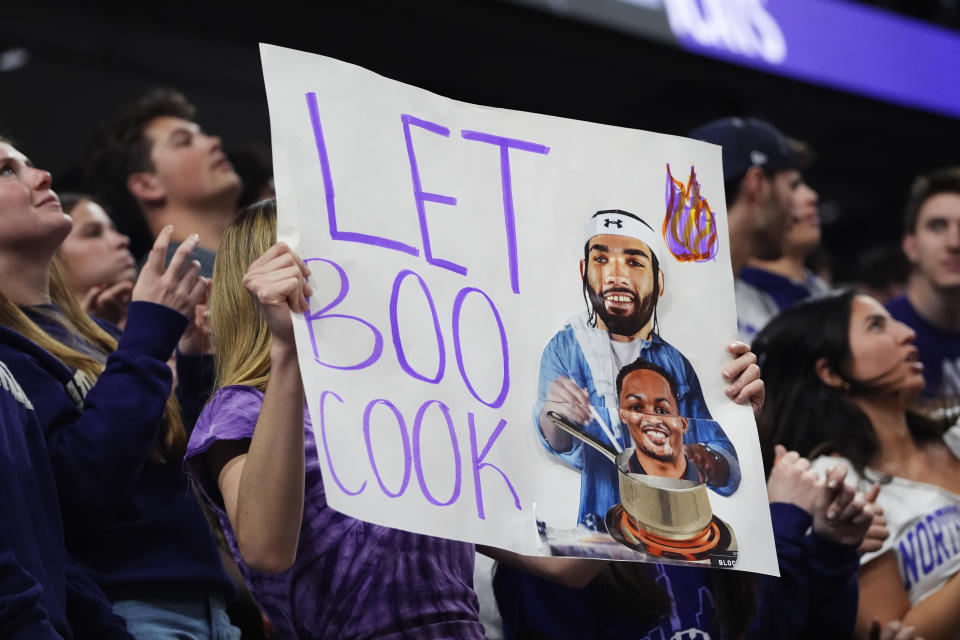 A Northwestern fan holds a sign during the second half of an NCAA college basketball game between Maryland and Northwestern in Evanston, Ill., Wednesday, Jan. 17, 2024. (AP Photo/Nam Y. Huh)