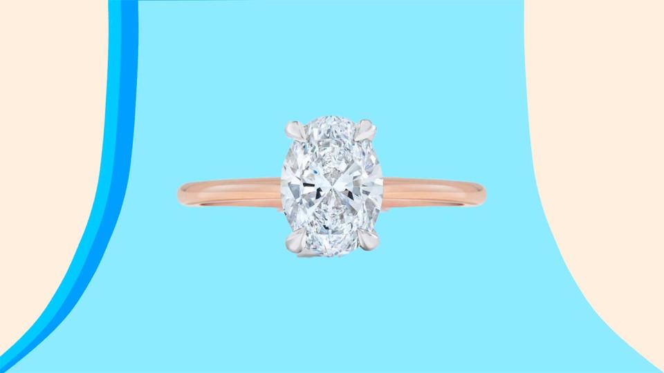 An oval-shaped engagement ring that's paired with a rose-gold band.