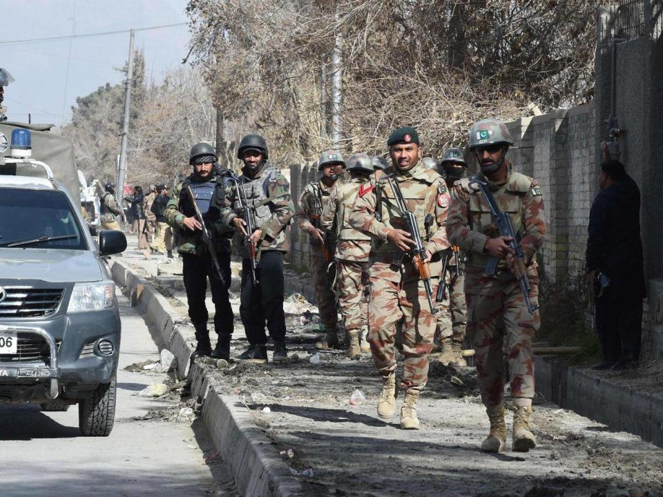 Pakistani security personnel advance after suicide bombers attacked a Methodist church during a Sunday service in Quett (Banaras Khan/AFP/Getty)