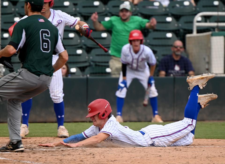 Pace High School Palmer Etheredge (15) slides into home plate to score a run during their state 6A baseball game with Melbourne High School in Fort Myers ,Friday, May 20, 2022.(Photo/Chris Tilley)