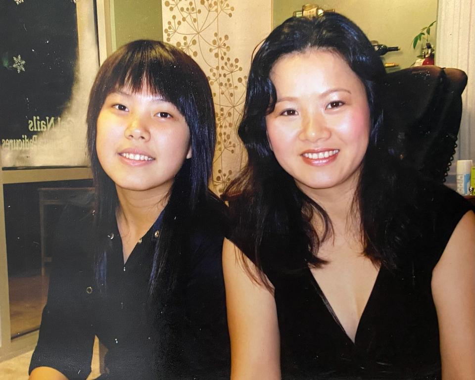 Jami Webb (left) and her mom Xiaojie Tan (right) pose for a picture at her first job at a nail salon in Florida.