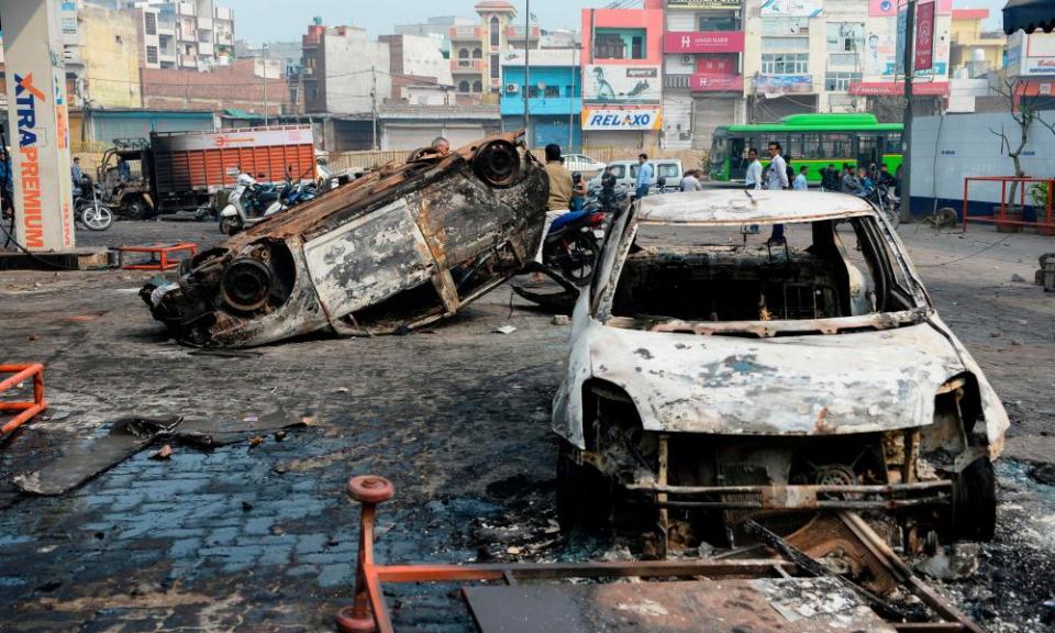 Burnt-out vehicles in the aftermath of the sectarian clashes in New Delhi.