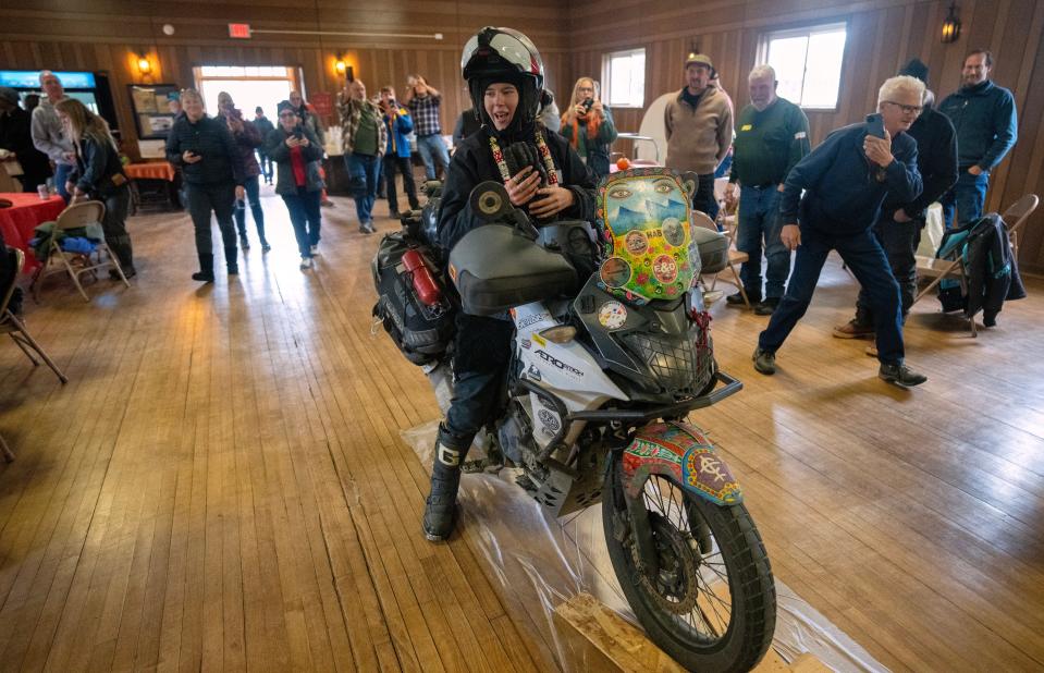 Bridget McCutchen, 22, arrives at a celebration Nov. 4 in Ashland, WIsconsin, shortly after setting a world record for being the youngest person to circumnavigate the world on her motorcycle. She started her journey in August 2022 and traveled through 45 countries.