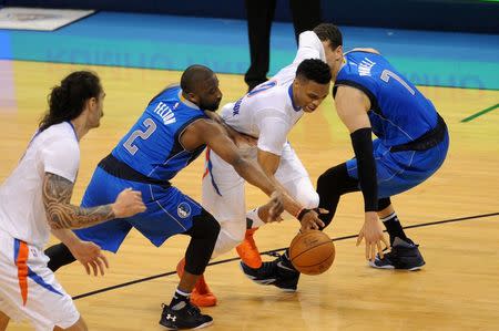 Apr 25, 2016; Oklahoma City, OK, USA; Oklahoma City Thunder guard Russell Westbrook (0) drives to the basket between Dallas Mavericks guard Raymond Felton (2) and forward Dwight Powell (7) during the second quarter in game five of the first round of the NBA Playoffs at Chesapeake Energy Arena. Mark D. Smith-USA TODAY Sports