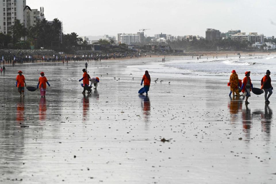 Civic staff and environmentalists clear rubbish from Versova Beach in Mumbai on World Environment Day (Getty Images)