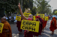 Buddhist monks lead an anti-coup protest march in Mandalay, Myanmar, Saturday, Feb. 27, 2021. Myanmar security forces cracked down on anti-coup protesters in the country's second-largest city Mandalay on Friday, injuring at least three people, two of whom were shot in the chest by rubber bullets and another who suffered a wound on his leg. "CRPH" in the placards stand for "Committee Representing Pyidaungsu Hluttaw." (AP Photo)