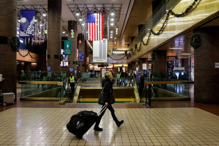 A woman walks through the New York Port Authority bus terminal following an attempted detonation during the morning rush hour in New York City, U.S. December 11, 2017. REUTERS/Brendan McDermid