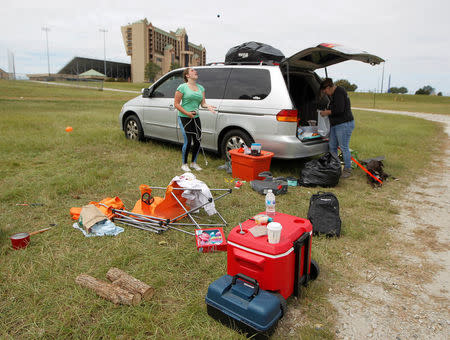 Izabell Hendon and her mother Cassandra of Vero Beach, Florida begin packing up their car after sleeping in a tent and being offered a condo to sleep in to ride out Hurricane Irma at Atlanta Motor Speedway in Hampton, Georgia, U.S., September 10, 2017. REUTERS/Tami Chappell