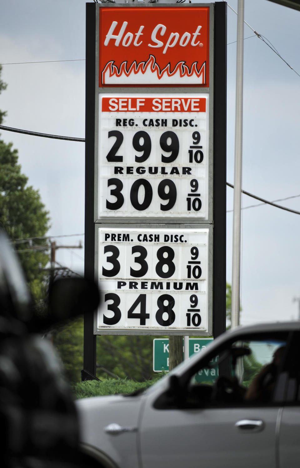 A sign for $2.99 a gallon gasoline is seen as vehicles wait for a traffic light to turn green at a Hot Spot convenience store on the corner of Henry and Converse Streets on Friday, June 1, 2012 in Spartanburg, S.C. Oil prices plunged as bleak reports on U.S. job growth and manufacturing heightened worries about a slowing global economy. (AP Photo/Rainier Ehrhardt)