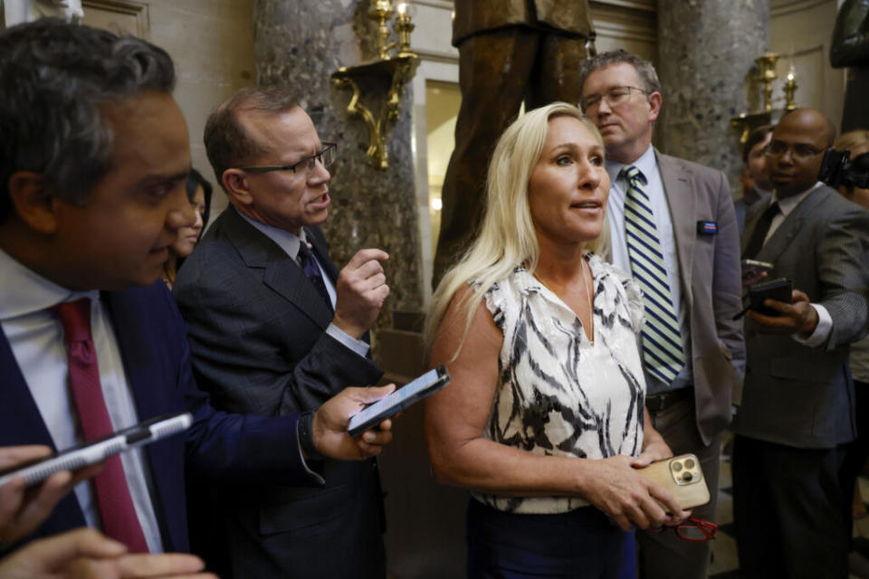 Rep. Marjorie Taylor Greene, R-Ga., and Rep. Thomas Massie, R-Ky., speak to reporters in Statuary Hall after meeting with U.S. Speaker of the House Mike Johnson, R-La., in the U.S. Capitol Building on May 06, 2024, in Washington, D.C. Last week, Greene threatened to move forward with a ‘motion to vacate’ over her dissatisfaction with the Speaker’s handling of the government funding legislation. (Photo by Anna Moneymaker/Getty Images)
