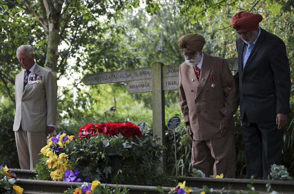 Veteran Darbara Singh Bhullar, 97, second right, stands alongside Britain's Prince Charles during the national service of remembrance marking the 75th anniversary of V-J Day at the National Memorial Arboretum in Alrewas, England, Saturday Aug. 15, 2020. Following the surrender of the Nazis on May 8, 1945, V-E Day, Allied troops carried on fighting the Japanese until an armistice was declared on Aug. 15, 1945. (Molly Darlington/PA via AP)