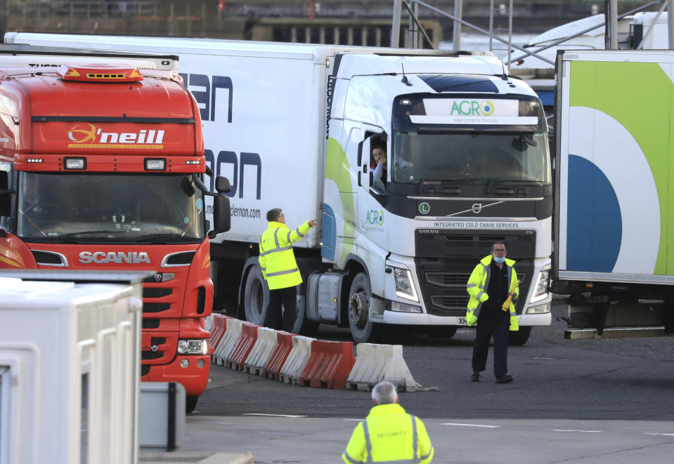 Customs officials check vehicles at the P&O ferry terminal in the port at Larne on the north coast of Northern Ireland, Friday, Jan. 1, 2021. This New Year's Day is the first day after Britain's Brexit split with the European bloc's vast single market for people, goods and services, and the split is predicted to impact the Northern Ireland border. (AP Photo/Peter Morrison)