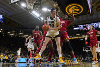 Iowa forward McKenna Warnock (14) grabs a rebound on front of Maryland guard Bri McDaniel (24) during the second half of an NCAA college basketball game, Thursday, Feb. 2, 2023, in Iowa City, Iowa. Iowa won 96-82. (AP Photo/Charlie Neibergall)