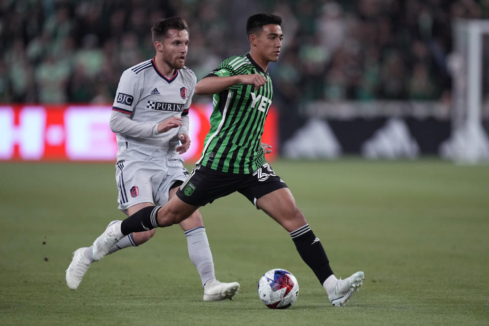 Austin FC midfielder Owen Wolff (33) moves the ball past St Louis City FC midfielder Rasmus Alm (21) during the first half of an MLS soccer match in Austin, Texas, Saturday, Feb. 25, 2023. (AP Photo/Eric Gay)