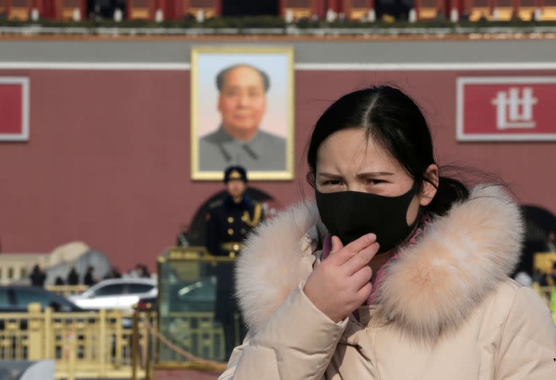 Tourist wearing a mask visits Tiananmen Square in Beijing