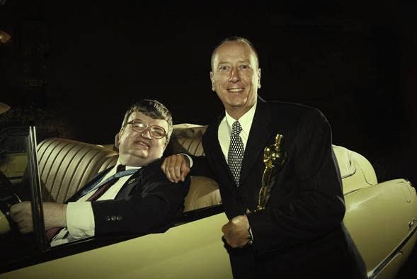 Oscar-winning <em>Rain Man</em> writer Barry Morrow posing with Kim Peek and his Oscar statuette. Peek is sitting in a 1949 Buick Roadmaster, identical to the one Tom Cruise and Dustin Hoffman drive in the movie. (Photo: Courtesy of Barry Morrow)