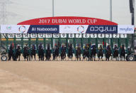 REFILE - CORRECTING BYLINE Horse Racing - Dubai World Cup - Meydan Racecourse, Dubai - 25/3/17 - Riders compete at the start of the fourth race. REUTERS/Stringer