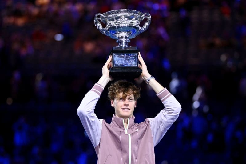 Italian tennis player Jannik Sinner poses with the Norman Brookes Challenge Cup following his victory over Russia's Daniil Medvedev in the Men’s Singles final tennis match of the 2024 Australian Open at Melbourne Park. Joel Carrett/AAP/dpa