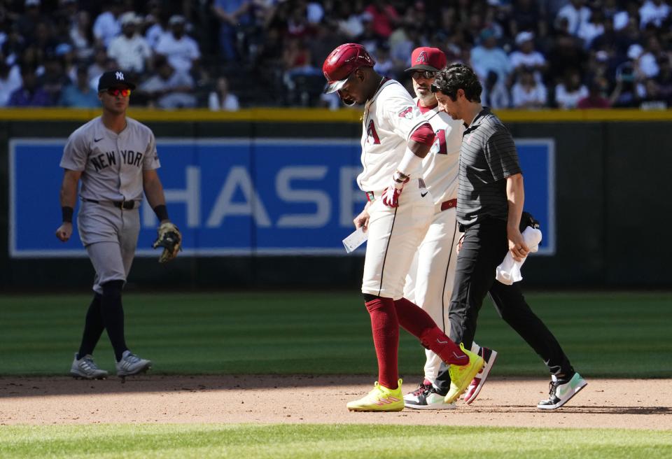 Arizona Diamondbacks' Geraldo Perdomo (2) leaves the game with an injury against the New York Yankees in the tenth inning at Chase Field in Phoenix on April 3, 2024.