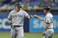 New York Yankees' DJ LeMahieu, left, celebrates with first base coach Reggie Willits after hitting a single off Tampa Bay Rays starting pitcher Michael Wacha during the third inning of a baseball game Wednesday, July 28, 2021, in St. Petersburg, Fla. (AP Photo/Chris O'Meara)