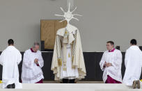 <p>Pope Francis holds up a monstrance during an open-air solemn Mass to canonize Jacinta and Francisco Marto, at the Sanctuary of Our Lady of Fatima, May 13, 2017, in Fatima, Portugal. Pope Francis urged Catholics on Friday to “tear down all walls” and spread peace as he traveled to this Portuguese shrine town to canonize two poor, illiterate shepherd children whose visions of the Virgin Mary 100 years ago marked one of the most important events of the 20th-century Catholic Church. (Photo: Armando Franca/AP) </p>