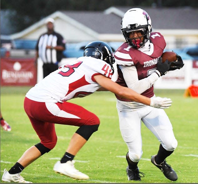 Nowata High School's Keyshawn Verner, right, makes a move on a Caney Valley High School defender during rivalry football action on Sept. 22, 2023, in Nowata.