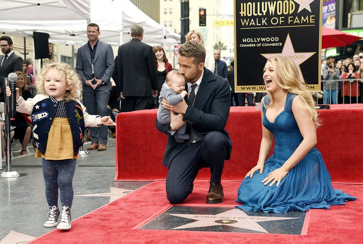 Ryan Reynolds' daughter James, left, steals the microphone as Reynolds poses with his wife, actress Blake Lively, and their youngest daughter during a ceremony to award him a star on the Hollywood Walk of Fame on Thursday, Dec. 15, 2016, in Los Angeles (Photo: Chris Pizzello/Invision/AP)