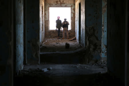 Rebel fighters stand in a damaged building in Quneitra countryside, Syria September 10, 2016. REUTERS/Alaa Al-Faqir