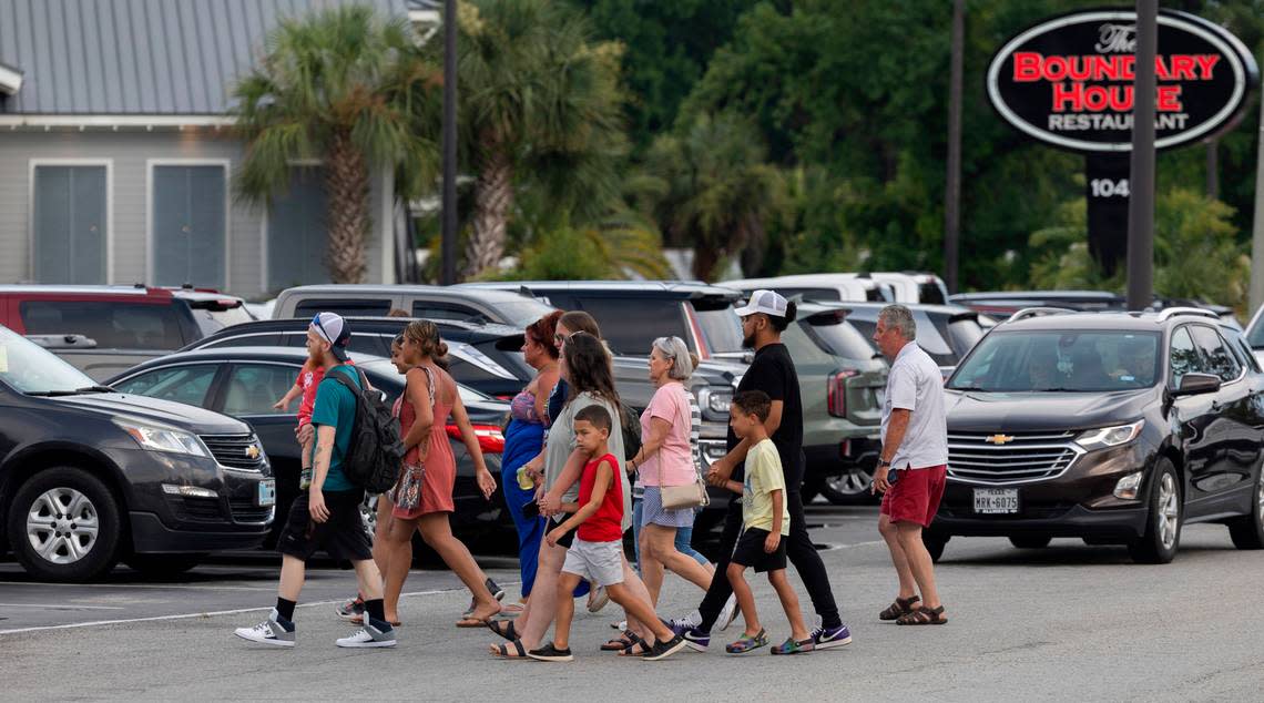 Vacationeers and visitors to Calabash, N.C. cross River Road, to shop at Callahan’s or visit any one of the many restaurants that line the street on Thursday, June 27, 2024 in Calabash, N.C.