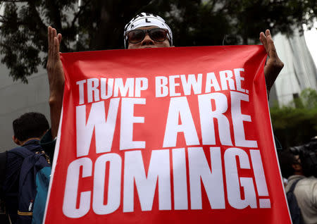 A pro-Palestine protester holds a banner as he marches towards the U.S. embassy in Kuala Lumpur, Malaysia December 8, 2017. REUTERS/Stringer