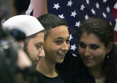 Florida teenager Tariq Khdeir, 15, smiles while surrounded by family members after his arrival from Israel at Tampa airport, Florida July 16, 2014. REUTERS/Scott Audette