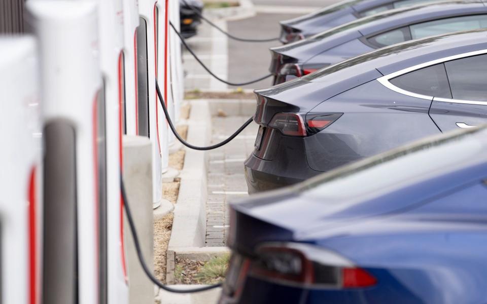 Tesla vehicles charge at a Tesla Supercharger station in Santa Monica, California, US, on Friday, Jan. 13, 2023. Tesla Inc. cut prices across its lineup in the US and major European markets in the carmakers latest effort to stoke demand after several quarters of disappointing deliveries. Photographer: Eric Thayer/Bloomberg