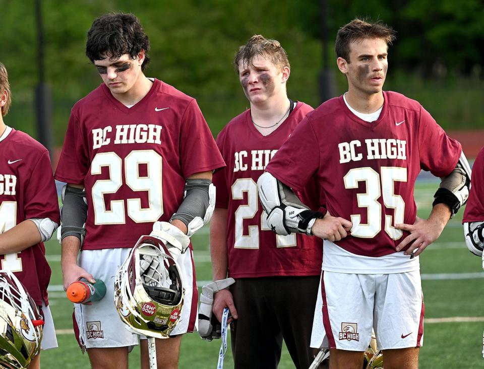 BC High players Tim Rogers, left, goalie Andrew Toland, and Will Emsing wait to receive their finalist medals after an 11-5 loss to St. John's Prep in the MIAA Division 1 boys lacrosse state championship at Worcester State University, June 21, 2022.