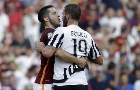 AS Roma's Konstantinos Manolas (L) reacts against Juventus' Leonardo Bonucci during their Serie A soccer match at Olympic stadium in Rome, Italy, August 30, 2015. REUTERS/Max Rossi