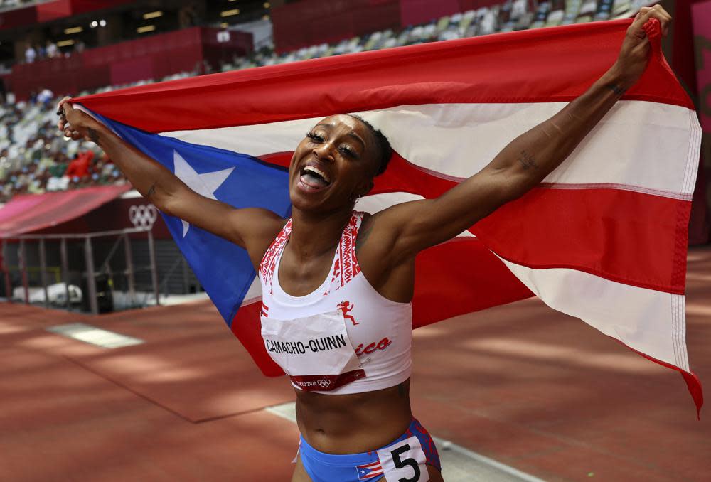 Jasmine Camacho-Quinn, of Puerto Rico celebrates after winning the gold in the women’s 100-meters hurdles final at the 2020 Summer Olympics, Monday, Aug. 2, 2021, in Tokyo, Japan. (Kai Pfaffenbach/Pool Photo via AP)