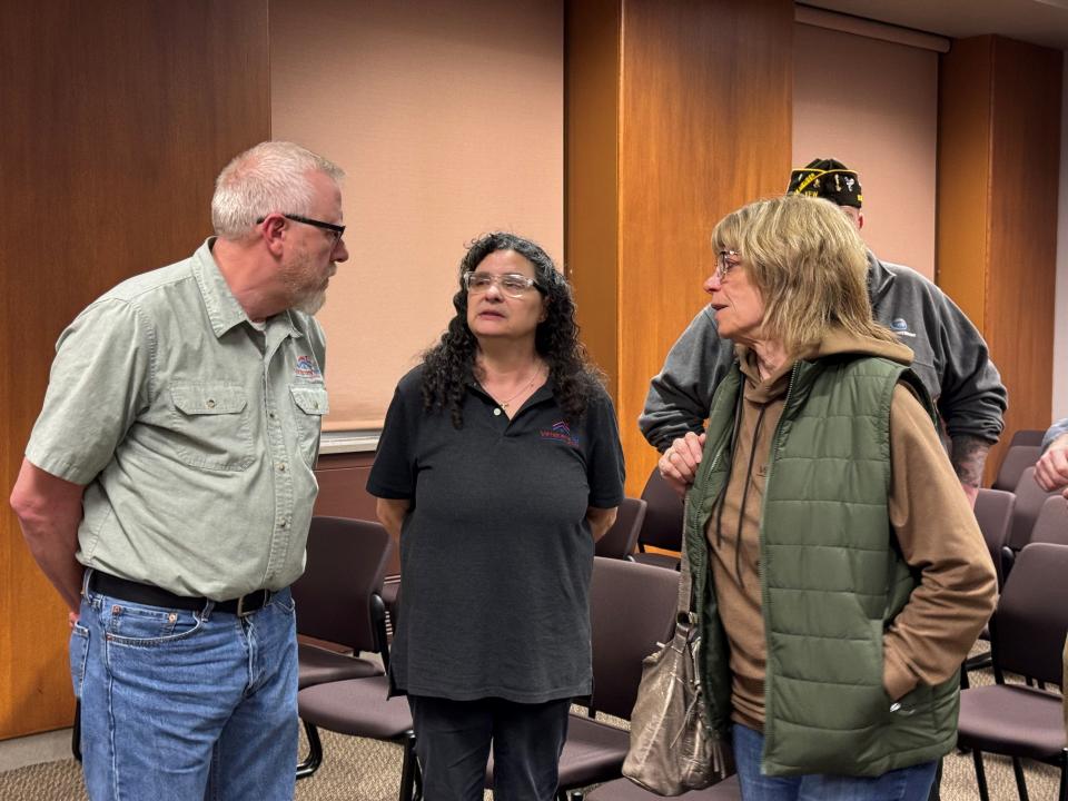 Gail Nohr, center, secretary of the Veterans 1st of NEW board of directors, talks with supporters about her proposal to build veteran-preferred supportive housing development in the 2800 block of St. Anthony Drive in Green Bay on Thursday.