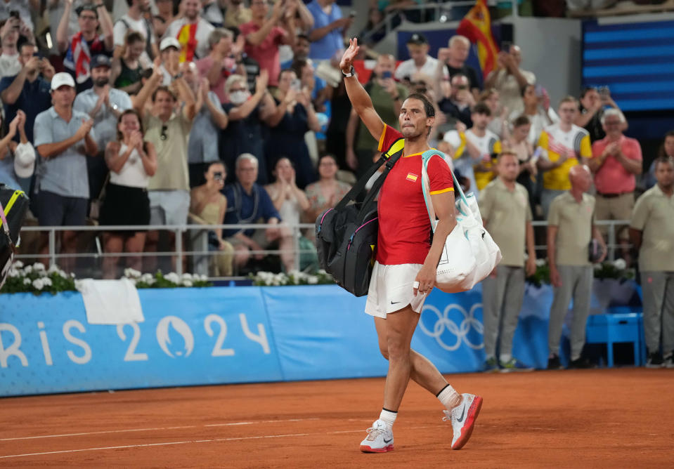 Rafael Nadal waves to the crowd after a men's doubles quarterfinal tennis match at the Paris Olympics at Stade Roland Garros in Paris on July 31, 2024.