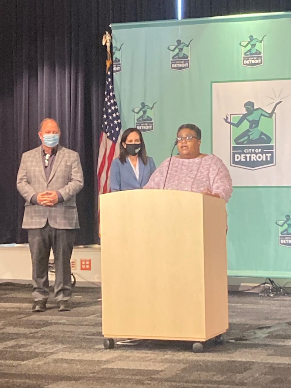 Detroit Mayor Mike Duggan, DIFS Director Anita Fox and Detroit resident Krysten Jones at the microphone during a Nov. 30 news conference in Detroit about auto insurance.