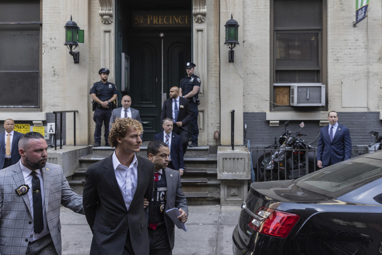 Daniel Penny, center, is walked by New York Police Department detectives detectives out of the 5th Precinct on Friday, May. 12, 2023 in New York. Manhattan prosecutors announced Thursday they would bring the criminal charge against Penny, 24, a U.S. Marine Corps veteran, in the May 1 death of 30-year-old Jordan Neely. (AP Photo/Jeenah Moon)