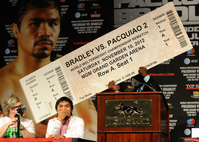   Boxer  Timothy Bradley (R) Holds Up An Oversize  Fake Ticket Predicting A Rematch With Trainer Freddie Roach (L) And  Getty Images