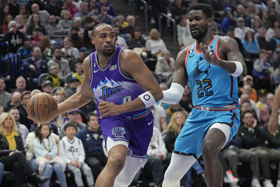 Utah Jazz guard Talen Horton-Tucker (0) drives as Phoenix Suns center Deandre Ayton (22) defends during the first half of an NBA basketball game Monday, March 27, 2023, in Salt Lake City. (AP Photo/Rick Bowmer)