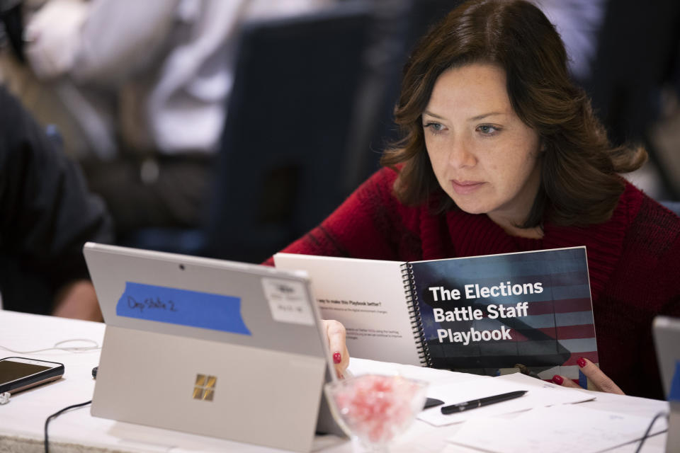 In this Monday, Dec. 16, 2019, photo, Mandy Vigil, from New Mexico, works during an exercise run by military and national security officials, for state and local election officials to simulate different scenarios for the 2020 elections, in Springfield, Va. These government officials are on the front lines of a different kind of high-stakes battlefield, one in which they are helping to defend American democracy by ensuring free and fair elections. (AP Photo/Alex Brandon)