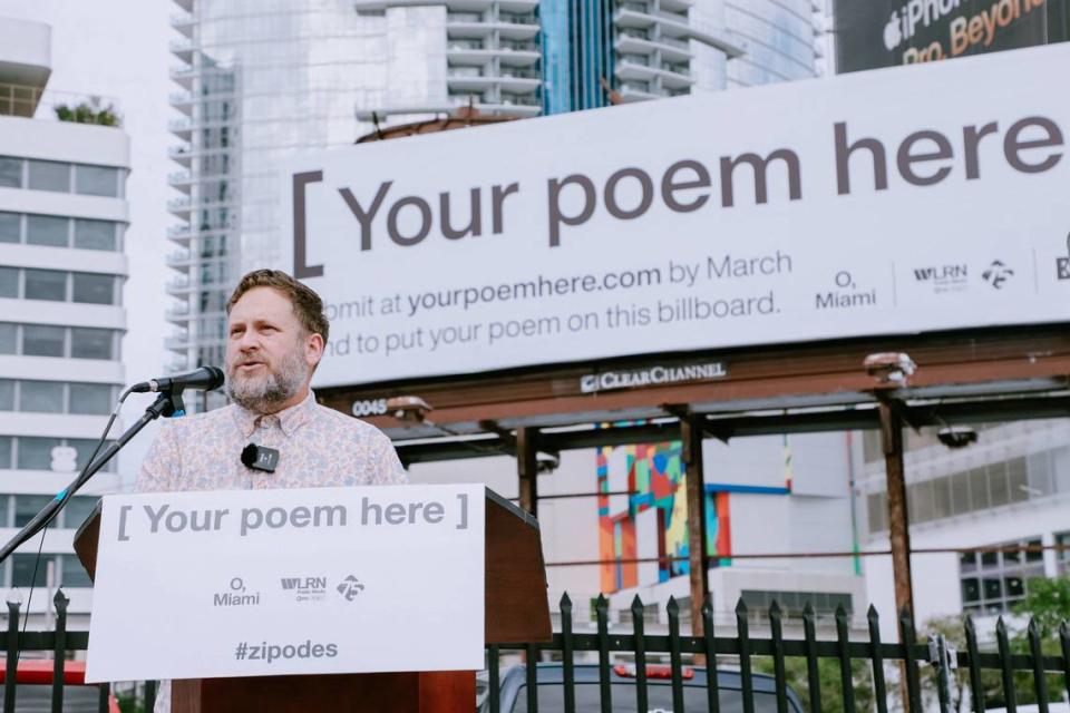 P. Scott Cunningham, the O, Miami founder and executive director, speaks in front of a billboard the organization purchased for its poetry contest.