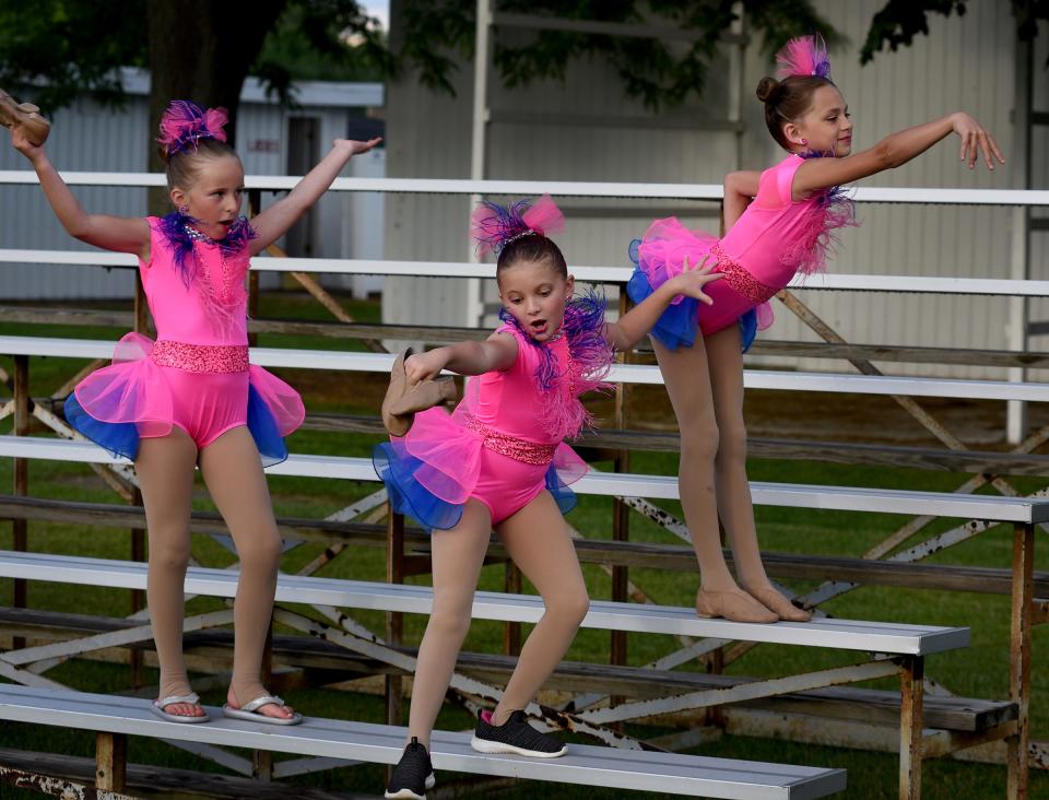 Girls with attitude as Mackenzie Cline, 8, Adalynn Rios, 8, and Brookelyne Cartwright, 9, act and dance on the bleachers at the Monroe County Fairgrounds early in June as they wait for the Viva Dance Co. second show. The girls were going to dance to "I Want Candy."