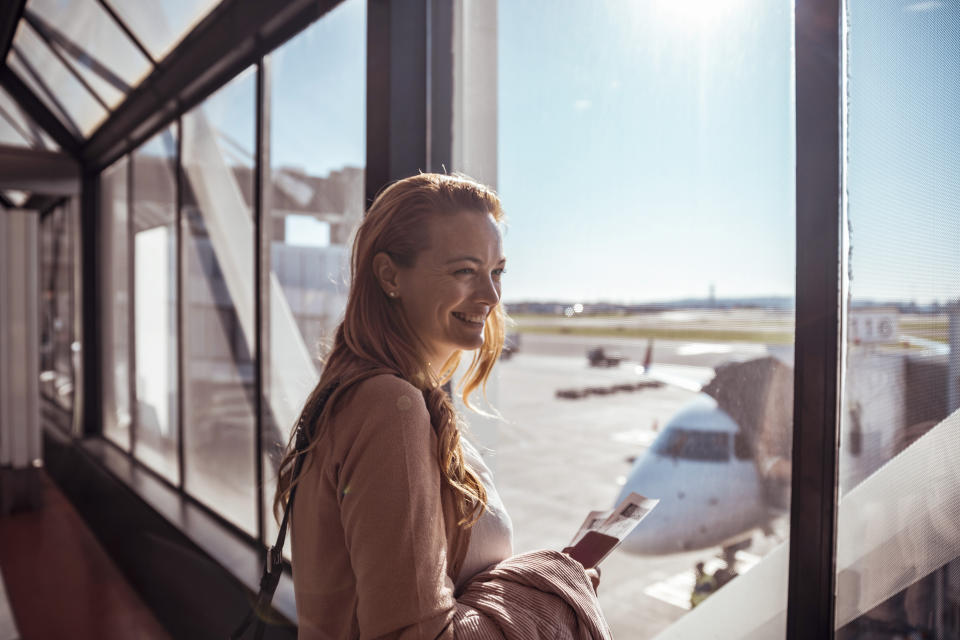 Close up of a young woman waiting to board the airplane at the airport