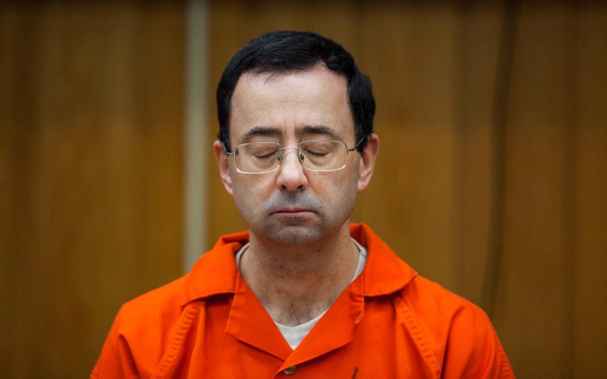 Larry Nassar, the US national women’s gymnastics team doctor, listens during his sentencing in 2018 - Cory Morse/The Grand Rapids Press via AP