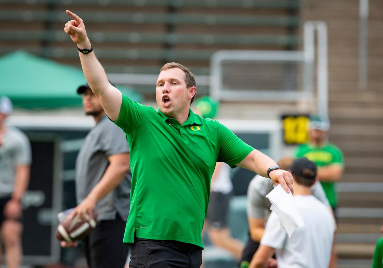 Kenny Dillingham, Oregon football’s co-offensive coordinator, leads drills during a “Saturday Night Live” event to host youth football players at Autzen Stadium Saturday, July 30, 2022. 