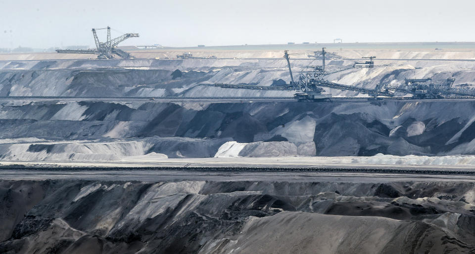 Giant bucket-wheel excavators extract coal at the controversial Garzweiler surface coal mine near Jackerath, west Germany, Thursday, April 29, 2021. Germany's top court ruled Thursday that the country's government has to set clear goals for reducing greenhouse gas emissions after 2030, arguing that current legislation doesn't go far enough in ensuring that climate change is limited to acceptable levels. (AP Photo/Martin Meissner)