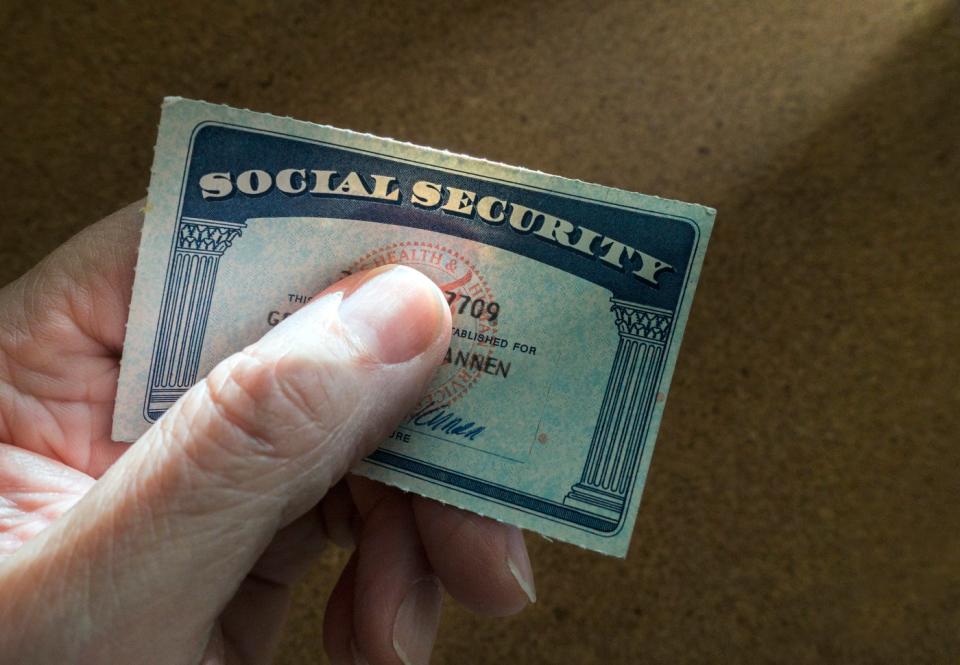 Hand holding a Social Security card.