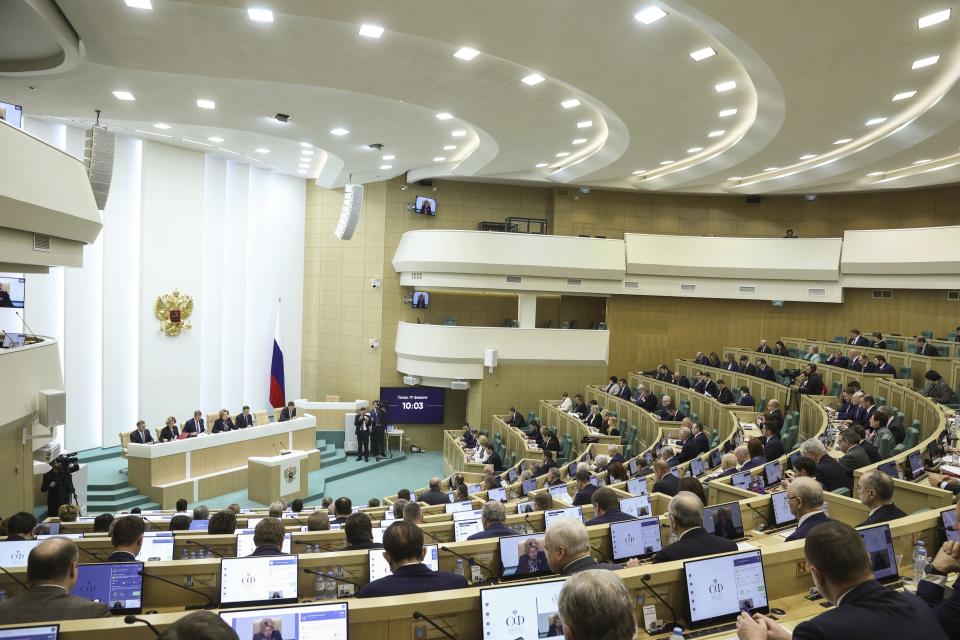 In this photo provided by The Federation Council of The Federal Assembly of The Russian Federation Press Service, lawmakers of Federation Council of the Federal Assembly of the Russian Federation attend a session in Moscow, Russia, on Wednesday, Feb. 7, 2024. The upper house of Russia's parliament has endorsed a bill that would allow authorities to confiscate money, valuables and other assets from people convicted of spreading "deliberately false information" about the country's military. (Federation Council of the Federal Assembly of the Russian Federation via AP)